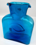 A turquoise glass water bottle.